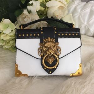 Elegant Black and White Crossbody Bag with Gold Accents